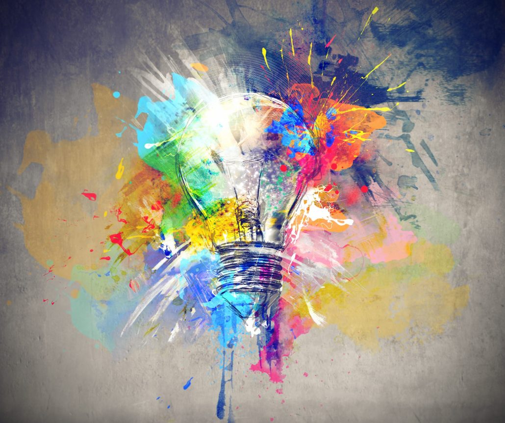 A colorful explosion of paint surrounds a light bulb, symbolizing creativity and inspiration in art and ideas.