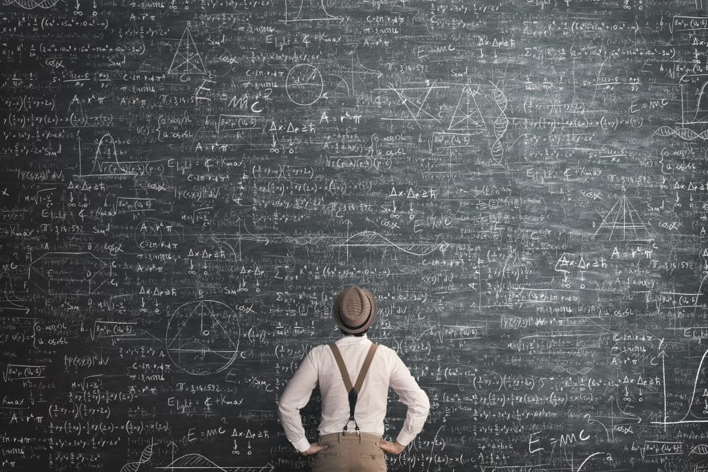 Person in vintage attire stands in front of a blackboard filled with complex mathematical equations and diagrams.